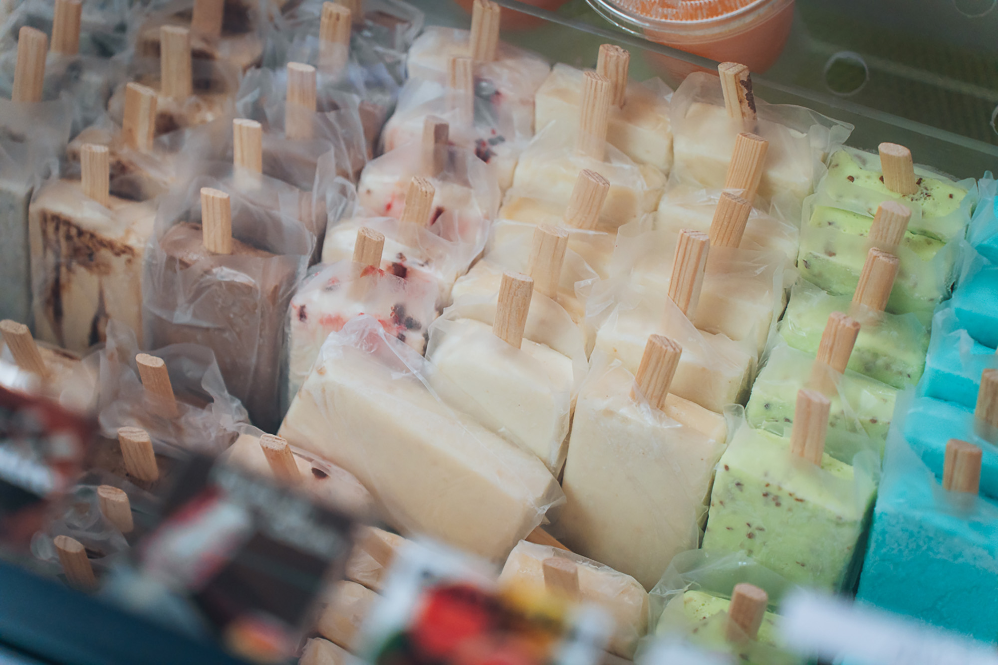 Paleta popsicles of different flavors on display at a snack bar.