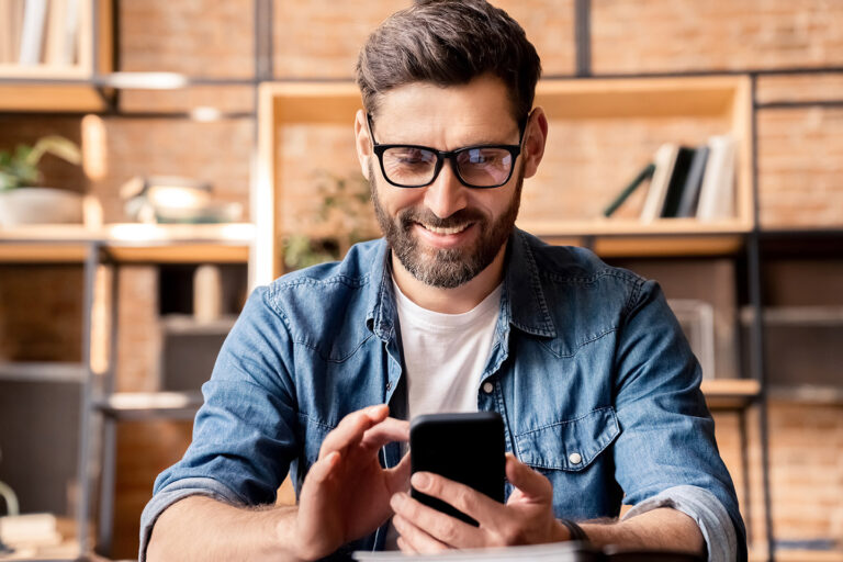 Happy smiling business man using smartphone device headshot portrait