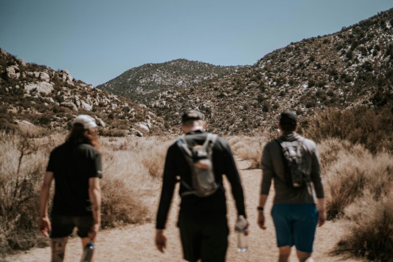 Three hikers in the Sandia mountain foothills