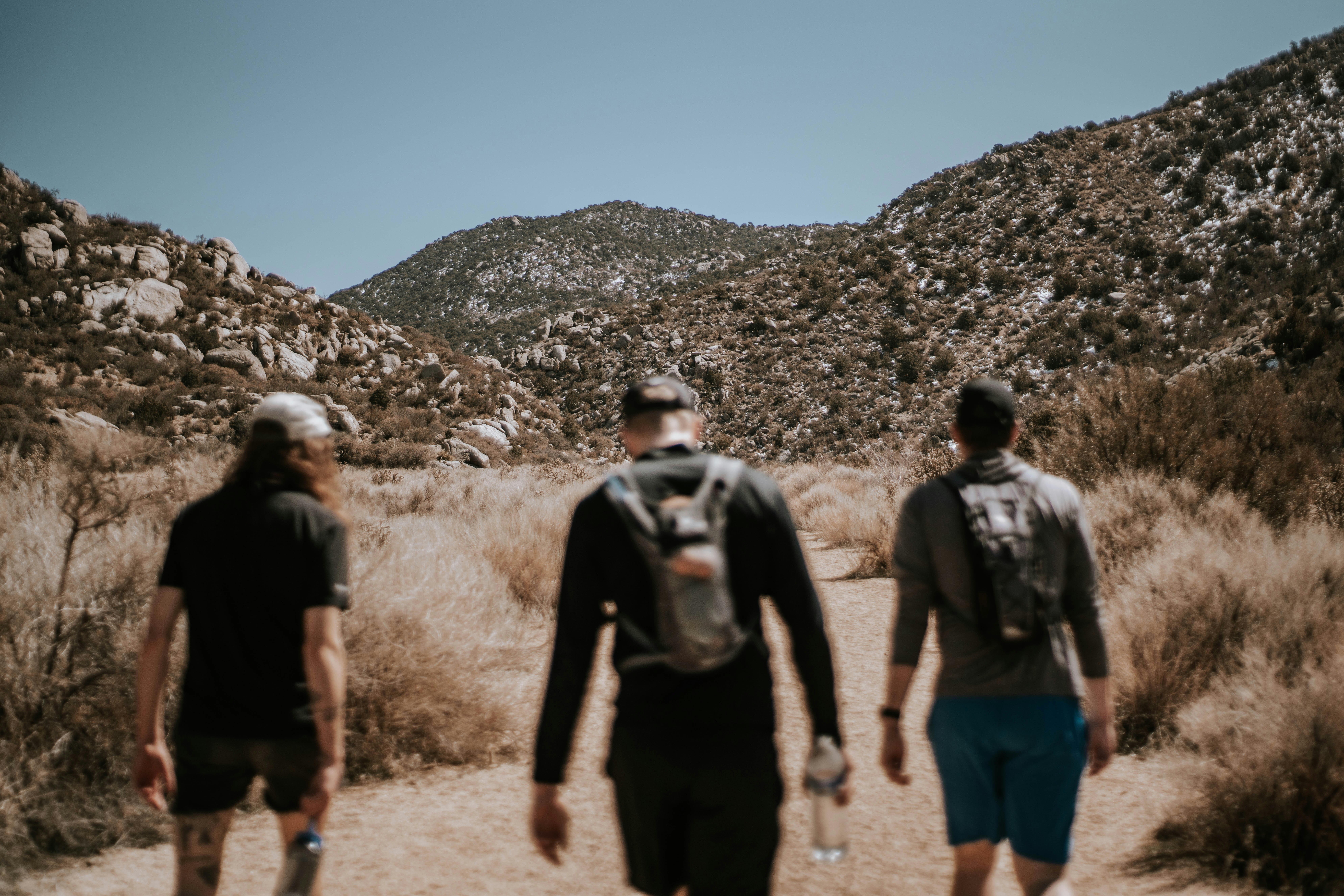 Three hikers in the Sandia mountain foothills